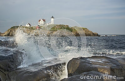 sea rock landscape with wave crushing. Nubble Lighthouse, historic lighthouse, Cape Neddick Point, York, Maine, USA. Stock Photo