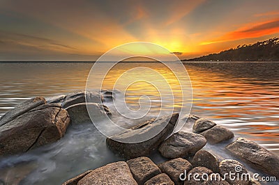 Sea rock wave at sunset Stock Photo