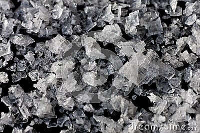 Sea salt flakes on a black background Stock Photo