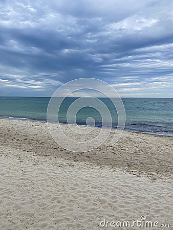 Sea, sand and storm clouds Stock Photo