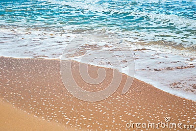 Sea sandy shore with an oncoming foam wave. Travel and tourism. Natural summer background Stock Photo