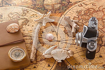 Sea shells, a compass, a wooden pencil and an old camera Stock Photo