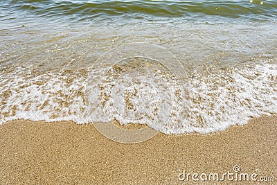 Sea shoreline with waves, sandy beach on a clear sunny day, close-up nature abstract background Stock Photo