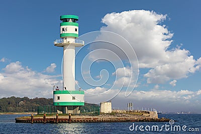 A green and white lighthouse in the Kiel Fjord in sunshine. Stock Photo