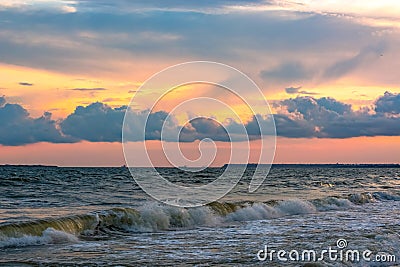 Sea with small waves and clouds at sunset Stock Photo