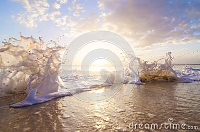 Sea splash at sunset Stock Photo