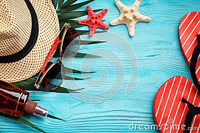 Sea stars, sea stones, palm leaves and shells lying on a blue wooden background . There is a place for labels. Stock Photo