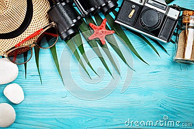 Sea stars, sea stones, palm leaves and shells lying on a blue wooden background . There is a place for labels. Stock Photo