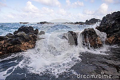 Sea with the stones and sand of a beach. Sea waves lash line impact rock. Stock Photo