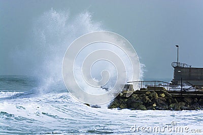 Sea storm waves crashing and splashing against jetty Stock Photo