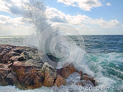 Sea surf. Splits waves against rocks in the sea Stock Photo