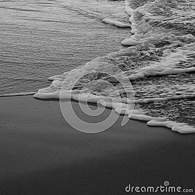 Sea water tide on the sand beach. Relax. Black and White shot Stock Photo