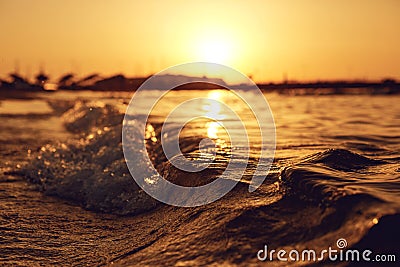 Sea wave on the beach at sunset Stock Photo