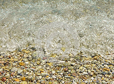 A sea wave hits the rocks on the beach Stock Photo