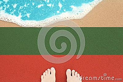 Sea wave on the sunny sandy beach with flag Bulgaria. View from top on surf Stock Photo