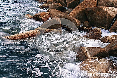 Sea waves break on stones Stock Photo