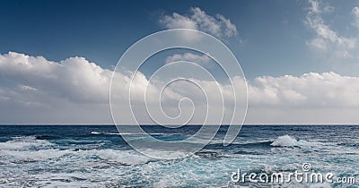 Sea waves crash on the rough rocky shore Stock Photo