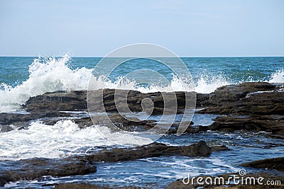 Sea waves crashing into rocks Stock Photo