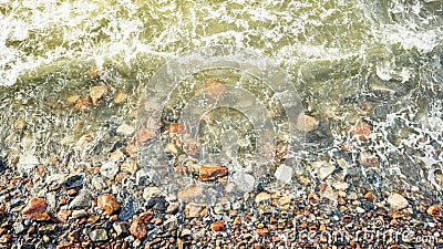 Sea waves slam into the sea rocks on the shore, sea foam on the shore rocks Stock Photo