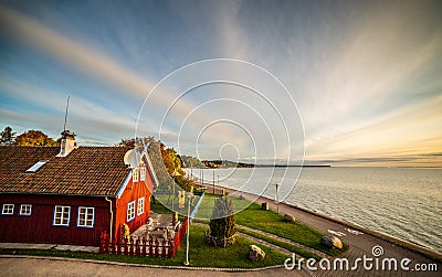 Sea and wooden house, sunset sky Stock Photo