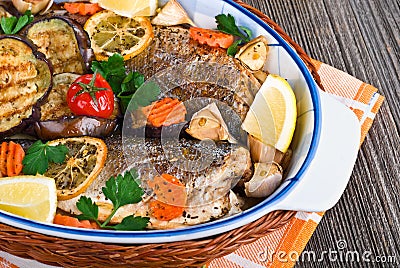 Seabass fish baked with vegetables, close-up Stock Photo