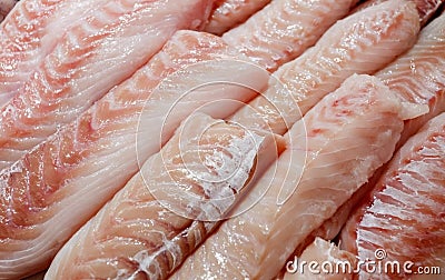 Seabass, hamour, grouper fish, sea bass fillet many pieces sliced piled bulk in fish market Stock Photo