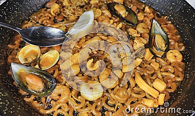 Seafood fideua in Valencia with mussels, squid and prawns Stock Photo