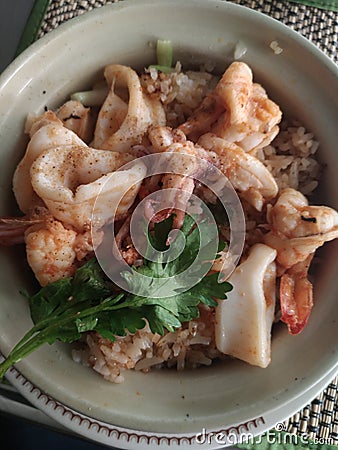 Seafood fried rice thai food yummy with shrimp squid and vegetable on bowl Stock Photo