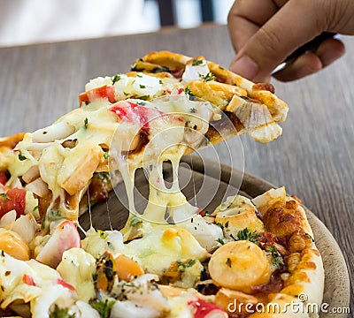 Seafood Italian Pizza slice on dish Stock Photo