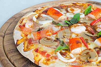 Seafood Italian Pizza slice on wood dish Stock Photo