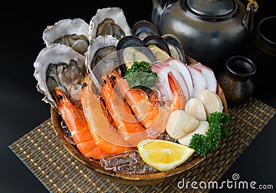 Seafood on a large plate set with dark background Stock Photo