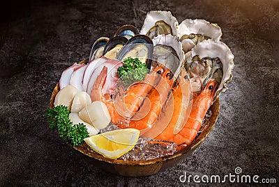 Seafood on a large plate set with dark background Stock Photo