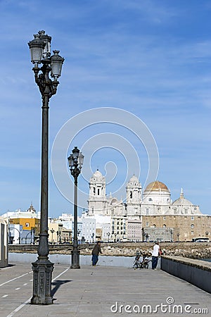 Seafront and rail bicycle to the evening, to the fund the cathedral of the holy cross, In cadiz, Andalusia, Spain Editorial Stock Photo