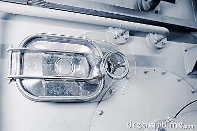 A sealed hatch in the food container. Industrial bottle washing machine body detail Stock Photo