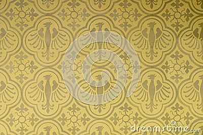 Seamless pattern of eagles and shapes of leafs in a wallpaper in gold yelloow and olive Stock Photo