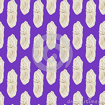 Seamless pattern of a skein of white rope on a purple background Stock Photo