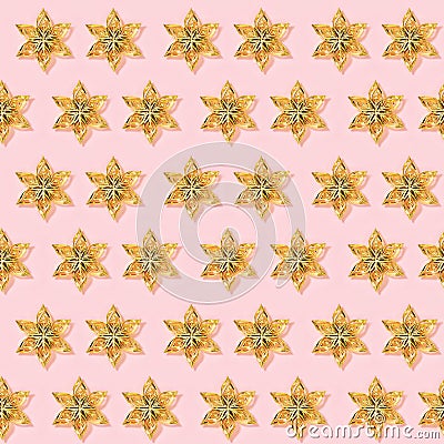 Seamless psttern wirh Christmas decorations, golden colored toys in shape star on pink paper Stock Photo