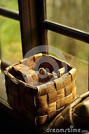Seamless small handmade splint baskets on window sill, with the window creating a reflecions of the baskets Stock Photo