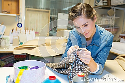 Seamstress hand sewing material in workshop Stock Photo