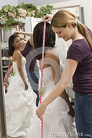 Seamstress measuring bride. Stock Photo