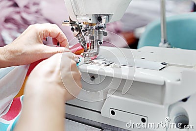 Sewing room, seamstress sews clothes on a sewing machine Stock Photo