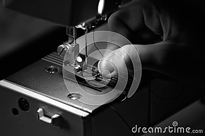 Seamstress Threading a Sewing Machine Stock Photo