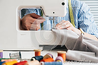 Seamstress working with electrical sewing machine Stock Photo