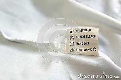 On the seamy side of the clothes there is a tag with instructions for use Stock Photo