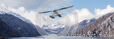 Seaplane Aircraft Flying over the Pacific Ocean Coast. Stock Photo