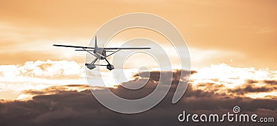 Seaplane flying over the Dramatic Cloudscape on the Pacific Ocean Coast. Stock Photo