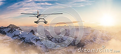 Seaplane flying over the Rocky Mountains during a colorful sunset. Stock Photo