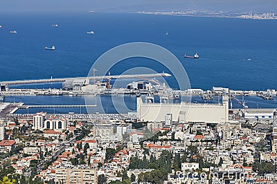 Seaport in the city of Haifa, panorama of the port and city buildings against the background of a blue sky with clouds. Editorial Stock Photo