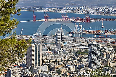 Seaport in the city of Haifa, panorama of the port and city buildings against the background of a blue sky with clouds. Editorial Stock Photo