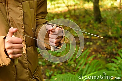 A girl with dowsing frames walksin forest. Psychic abilities Stock Photo